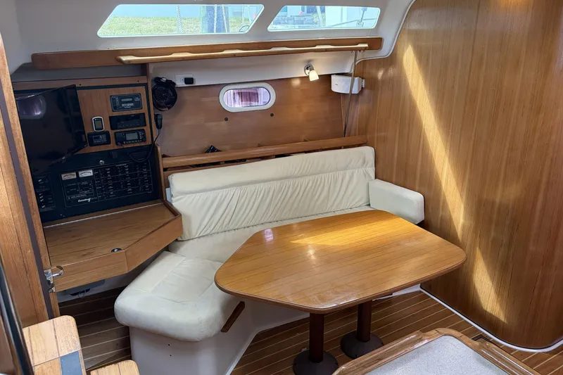 Slide: The Image of Interior of 2004 Catalina 36 MkII sailboat with wooden table and cushioned seating. - 23