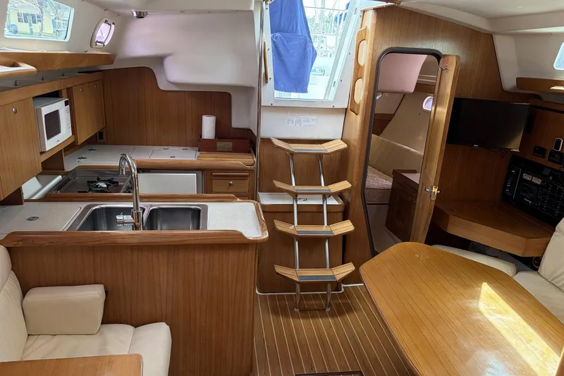 Slide: The Image of Interior of 2004 Catalina 36 MkII sailboat with wood finish and modern amenities. - 25