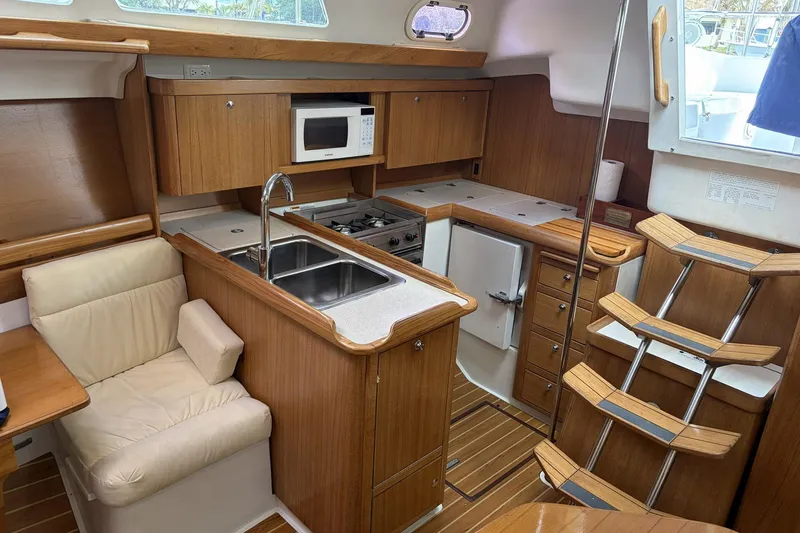 Slide: The Image of Interior of 2004 Catalina 36 MkII sailboat with wood cabinetry and compact kitchen. - 27