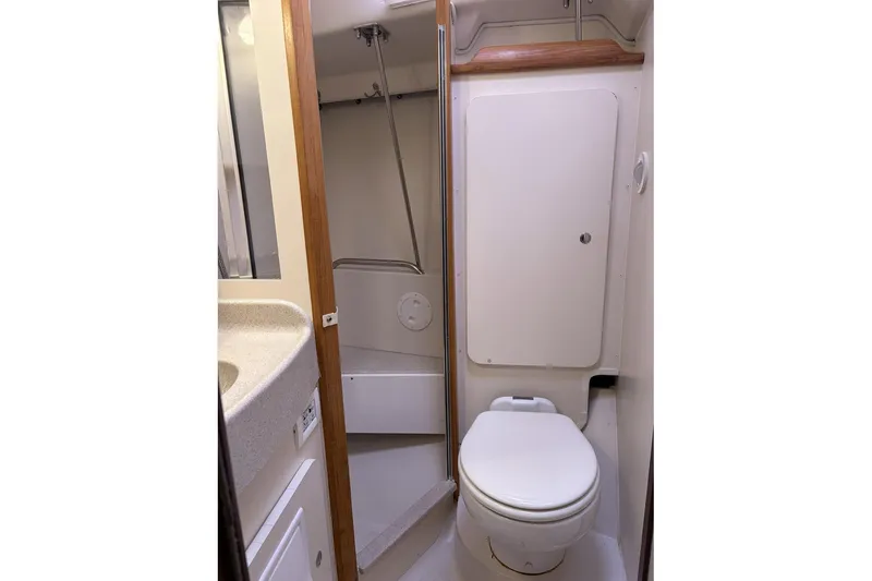 Slide: The Image of 2004 Catalina 36 MkII yacht bathroom with toilet, sink, and shower area. - 35