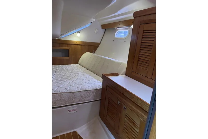 Slide: The Image of 2004 Catalina 36 MkII cabin interior with bed and wooden cabinetry. - 37