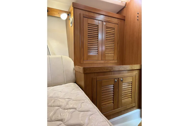 Slide: The Image of Wooden cabinetry and cushioned seating inside a 2004 Catalina 36 MkII sailboat cabin. - 39