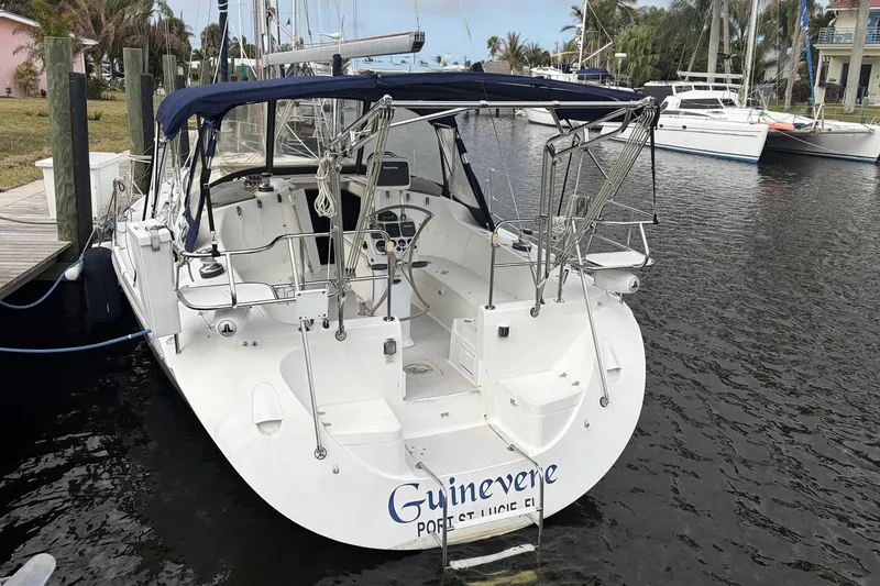 Slide: The Image of Catalina 36 MkII 2004 sailboat docked, featuring spacious cockpit and blue canopy. - 5