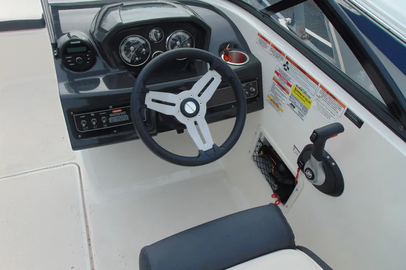 Slide: The Image of 2021 Bayliner VR5 Bowrider I/O dashboard with steering wheel and control panel. - 13
