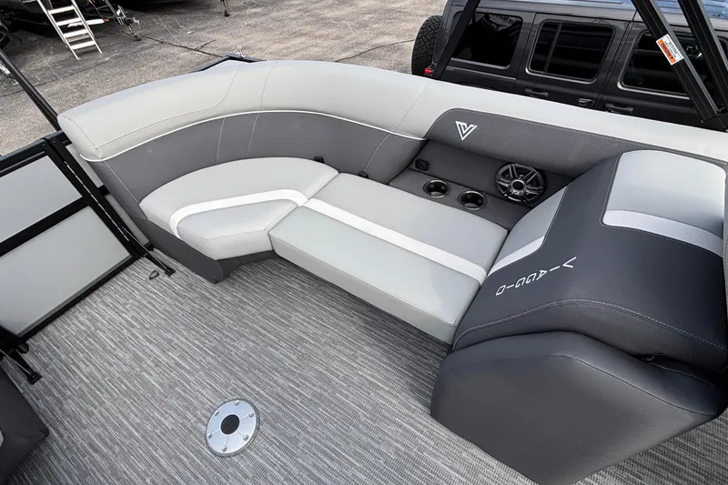 Slide: The Image of 2026 Viaggio X24U boat interior with gray seating, cup holders, and speaker system. - 14