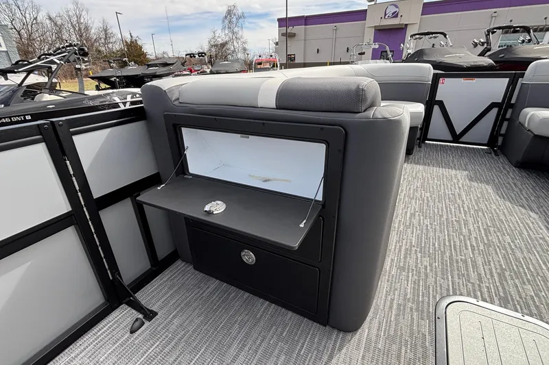 Slide: The Image of 2026 Viaggio X24U boat interior with open storage compartment and gray seating. - 25