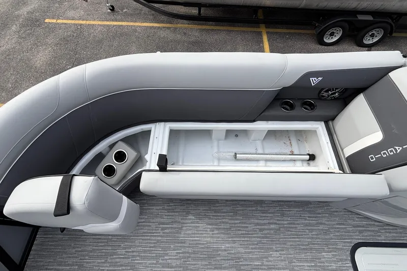 Slide: The Image of Interior view of 2026 Viaggio X24U boat with open storage compartment and cup holders. - 31