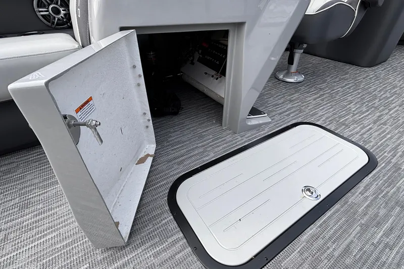 Slide: The Image of Open storage compartment on 2026 Viaggio X24U boat, featuring gray interior and carpeted flooring. - 32