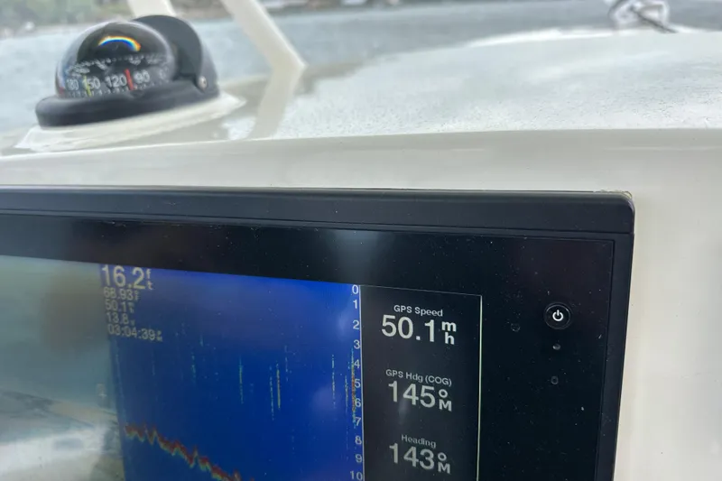 Slide: The Image of Dashboard of 2016 Cobia 277 Center Console showing GPS speed and heading. - 13