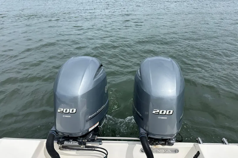 Slide: The Image of Twin Yamaha 200 engines on a 2016 Cobia 277 Center Console boat. - 14
