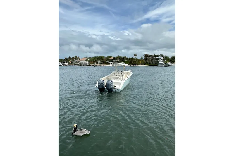Slide: The Image of 2016 Cobia 277 Center Console boat on water with pelican nearby. - 5
