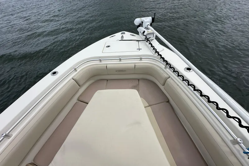 Slide: The Image of 2016 Cobia 277 Center Console boat bow with seating, on calm water. - 6
