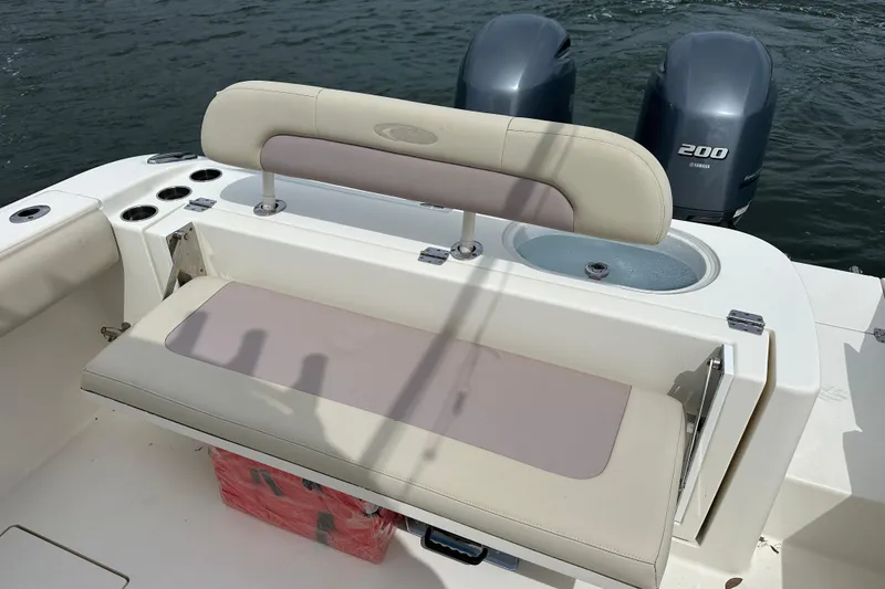 Slide: The Image of 2016 Cobia 277 Center Console boat with Yamaha 200 engines and seating area. - 8