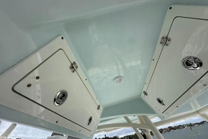 Slide: The Image of 2016 Cobia 277 Center Console boat storage compartments and ceiling view. - 9