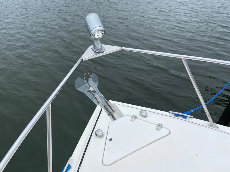 Slide: The Image of Bow of 2000 Rinker Fiesta Vee 310 boat with anchor and water. - 12