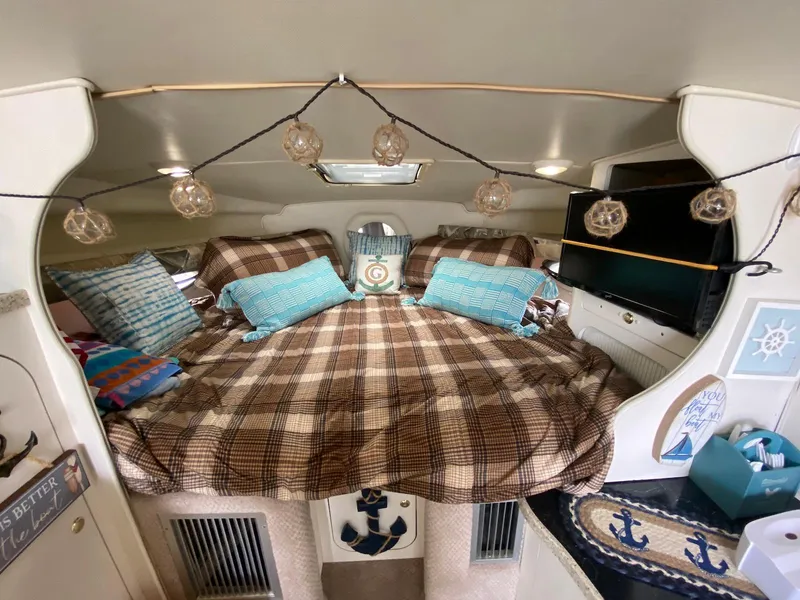 Slide: The Image of Interior of Rinker Fiesta Vee 310 yacht, cozy bedroom with nautical decor. - 19
