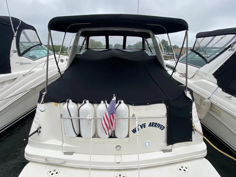 Slide: The Image of Rinker Fiesta Vee 310 boat, 2000 model, with cover and flag. - 2