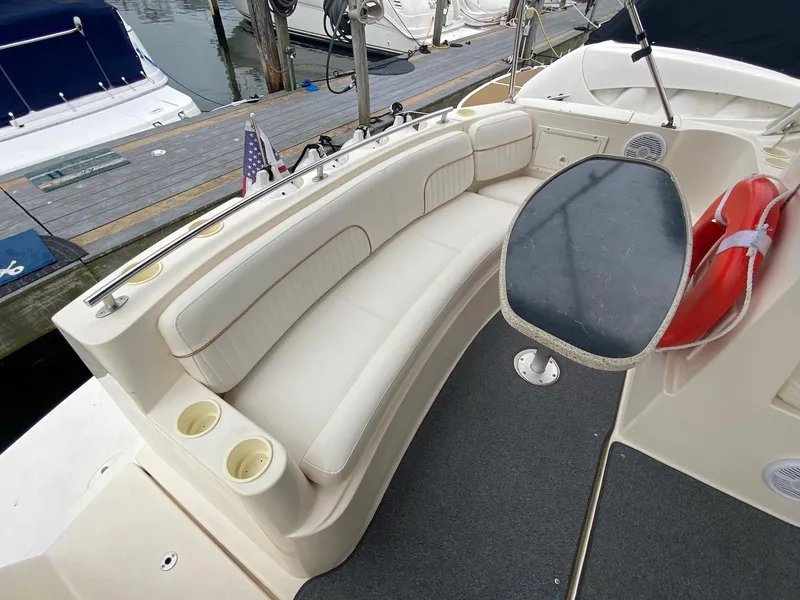 Slide: The Image of 2000 Rinker Fiesta Vee 310 boat with seating area and table. - 4
