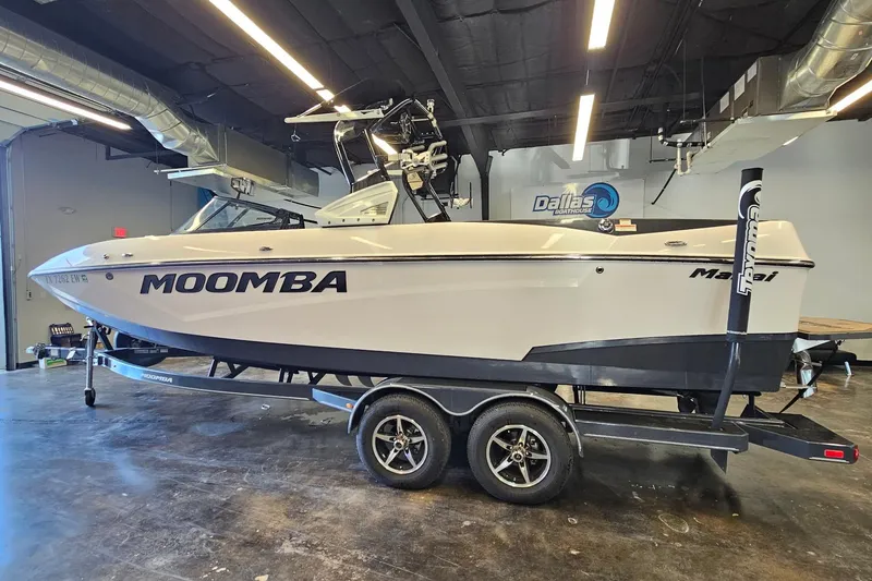 Slide: The Image of 2019 Moomba Makai boat on trailer in indoor showroom setting. - 11