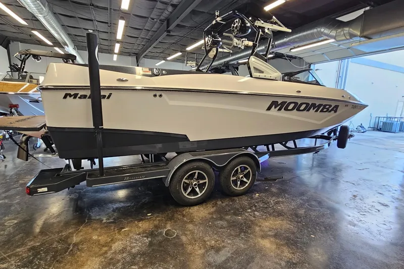 Slide: The Image of 2019 Moomba Makai boat on trailer in indoor showroom setting. - 12