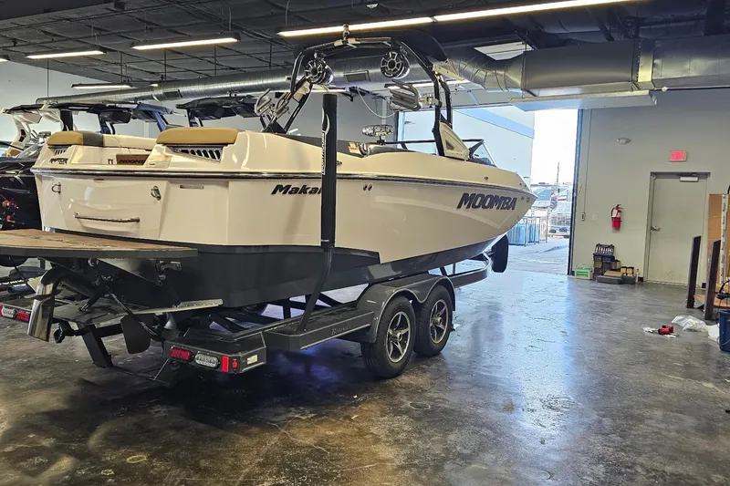Slide: The Image of 2019 Moomba Makai boat on trailer in indoor showroom setting. - 13