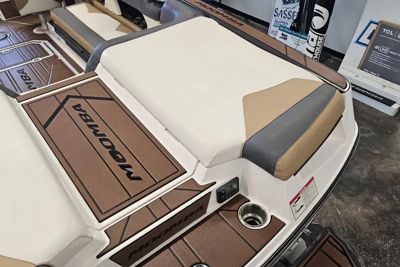 Slide: The Image of 2019 Moomba Makai boat interior with brown and beige seating and flooring. - 16