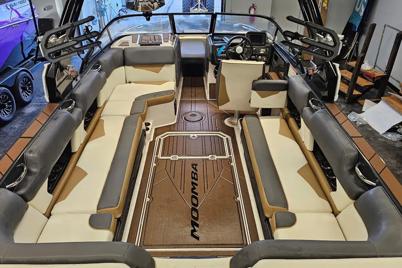 Slide: The Image of 2019 Moomba Makai boat interior with spacious seating and modern dashboard. - 18