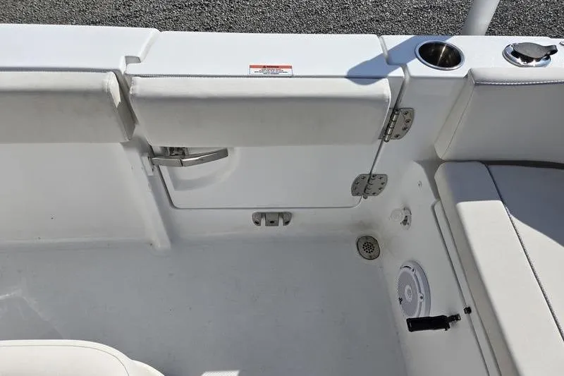 Slide: The Image of 2023 Sea Hunt Ultra 239 SE boat interior, featuring seating and cup holder. - 10