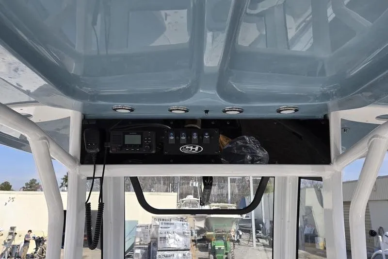 Slide: The Image of 2023 Sea Hunt Ultra 239 SE boat console with electronics and overhead storage. - 11