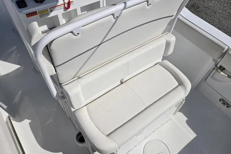 Slide: The Image of 2023 Sea Hunt Ultra 239 SE boat interior with white cushioned seating. - 12