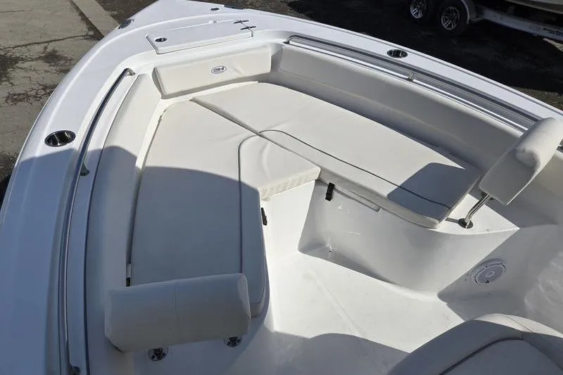 Slide: The Image of 2023 Sea Hunt Ultra 239 SE boat interior with white cushioned seating. - 13