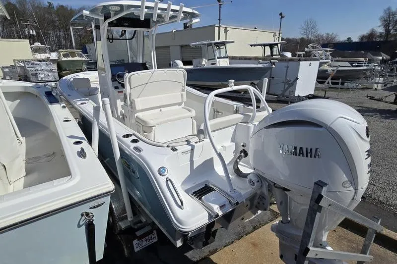 Slide: The Image of 2023 Sea Hunt Ultra 239 SE boat with Yamaha engine, docked in a marina. - 5