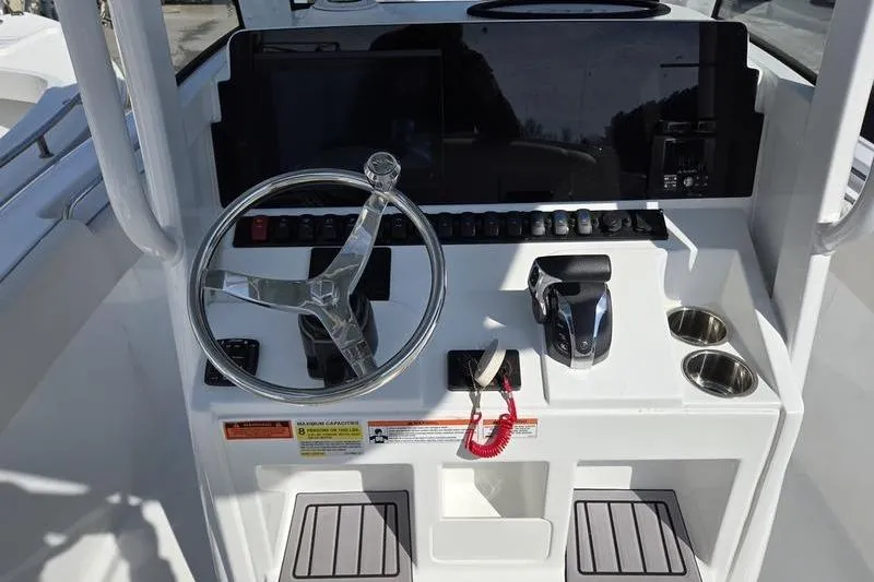 Slide: The Image of 2023 Sea Hunt Ultra 239 SE boat console with steering wheel and controls. - 6