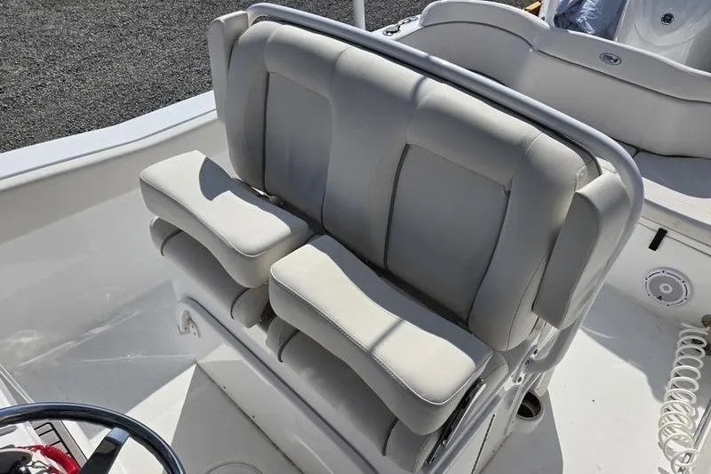 Slide: The Image of 2023 Sea Hunt Ultra 239 SE boat interior with cushioned seating. - 7