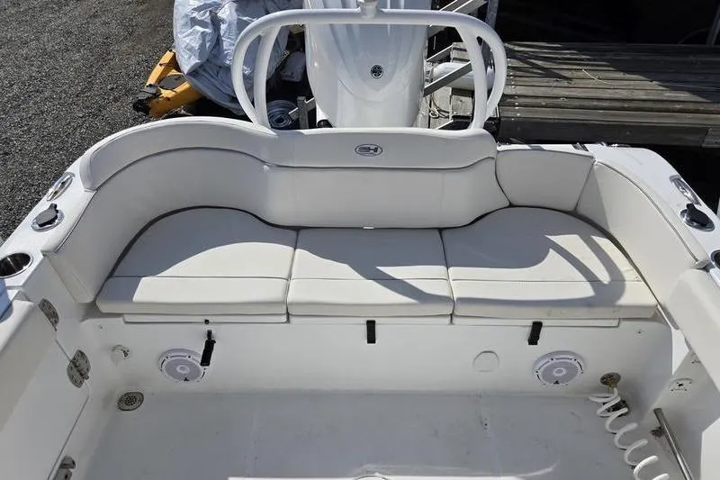 Slide: The Image of 2023 Sea Hunt Ultra 239 SE boat interior with white cushioned seating. - 9