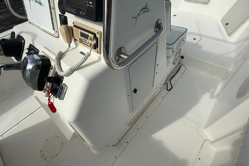 Slide: The Image of 1995 Marlin 210 boat cockpit with control panel and seating area. - 14