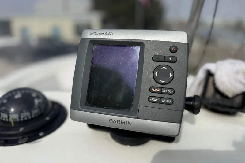 Slide: The Image of Garmin GPSmap 441s on 1995 Marlin 210 boat dashboard, with compass nearby. - 15