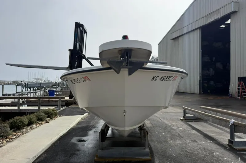 Slide: The Image of 1995 Marlin 210 boat on trailer near marina and storage facility. - 17