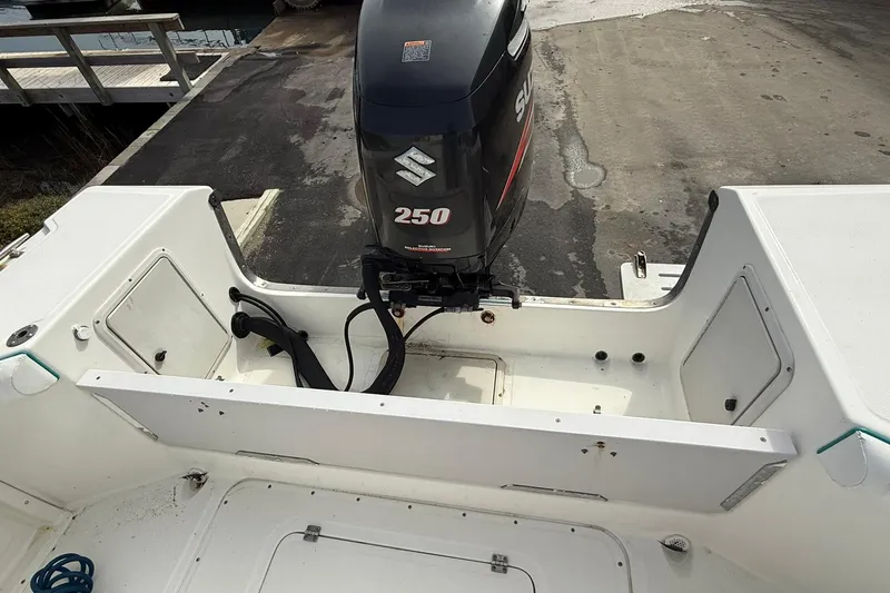 Slide: The Image of 1995 Marlin 210 boat with Suzuki 250 outboard motor at dock. - 7