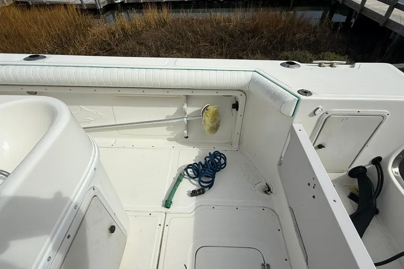 Slide: The Image of 1995 Marlin 210 boat interior with cleaning supplies and coiled hose. - 8