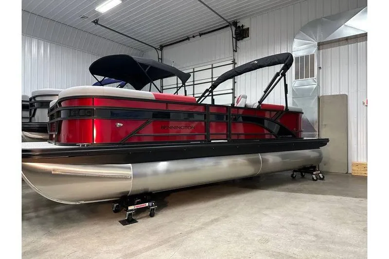 The Image of 2026 Bennington 22 SSR Quad Bench pontoon boat in stock, displayed indoors. - 1