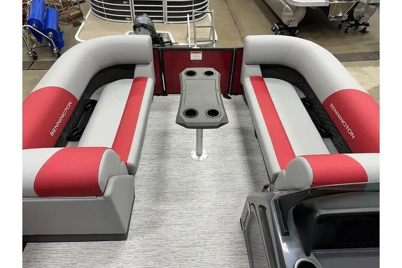 Slide: The Image of 2026 Bennington 22 SSR Quad Bench with red and gray seating, featuring a central table. - 15
