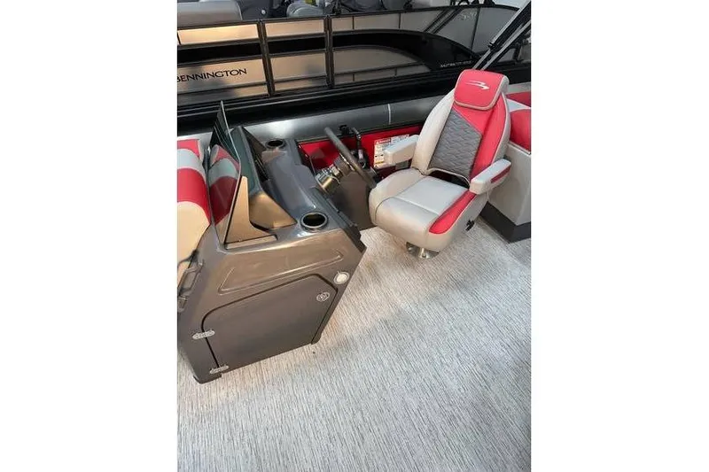 Slide: The Image of 2026 Bennington 22 SSR Quad Bench interior with captain's chair and control console. - 16