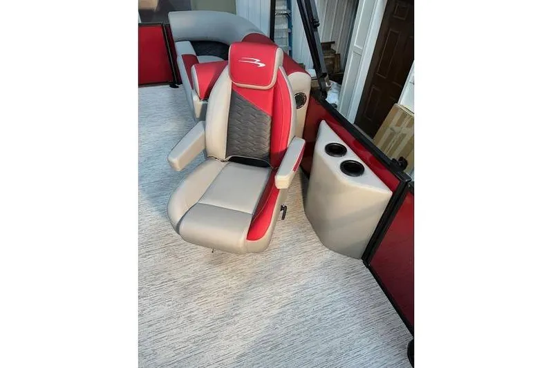Slide: The Image of 2026 Bennington 22 SSR Quad Bench boat seat, red and gray design, with cup holders. - 17