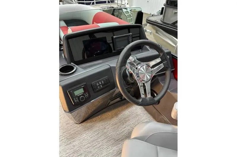 Slide: The Image of 2026 Bennington 22 SSR Quad Bench boat dashboard with modern steering wheel and controls. - 20