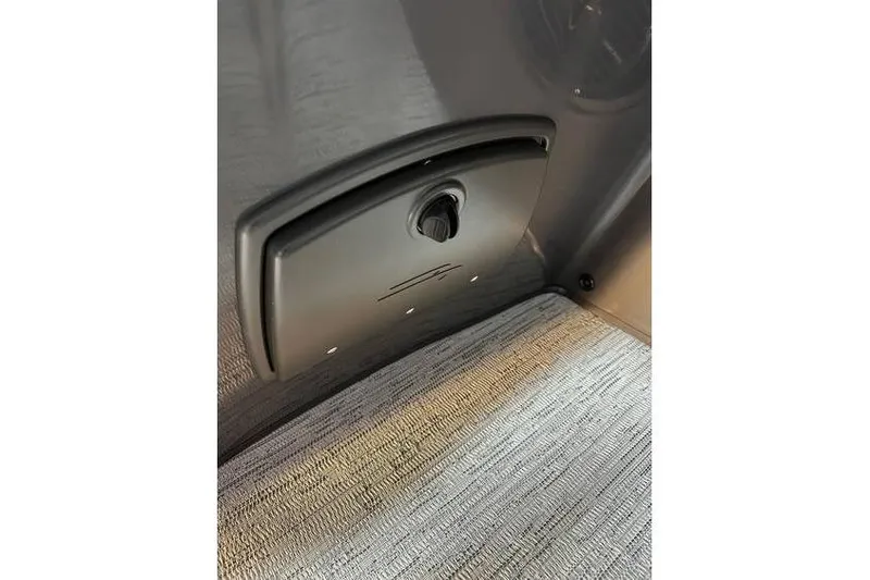 Slide: The Image of 2026 Bennington 22 SSR Quad Bench interior detail with textured flooring and control panel. - 26