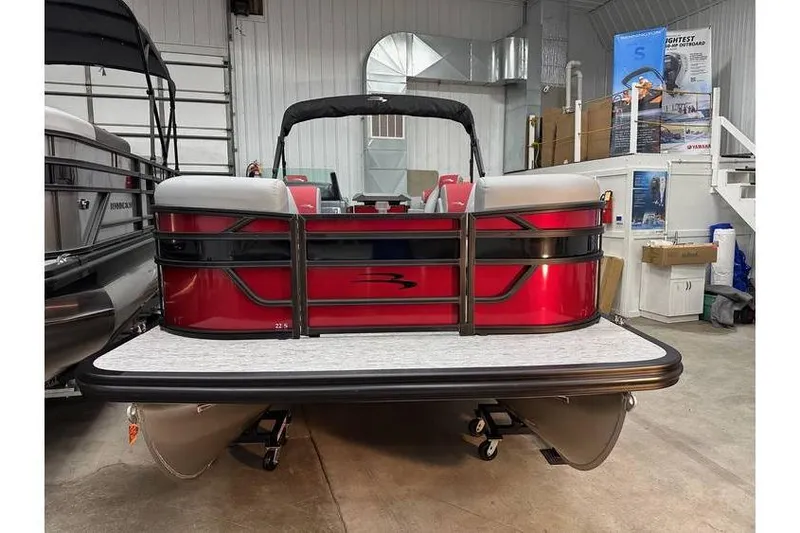 Slide: The Image of 2026 Bennington 22 SSR Quad Bench pontoon boat in showroom, red exterior, available in stock. - 3