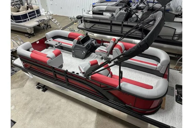 Slide: The Image of 2026 Bennington 22 SSR Quad Bench pontoon boat with red and gray seating, in stock. - 31