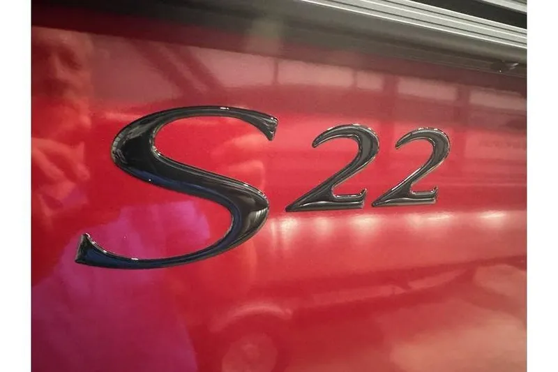 Slide: The Image of Close-up of 2026 Bennington 22 SSR Quad Bench logo on red surface. - 38