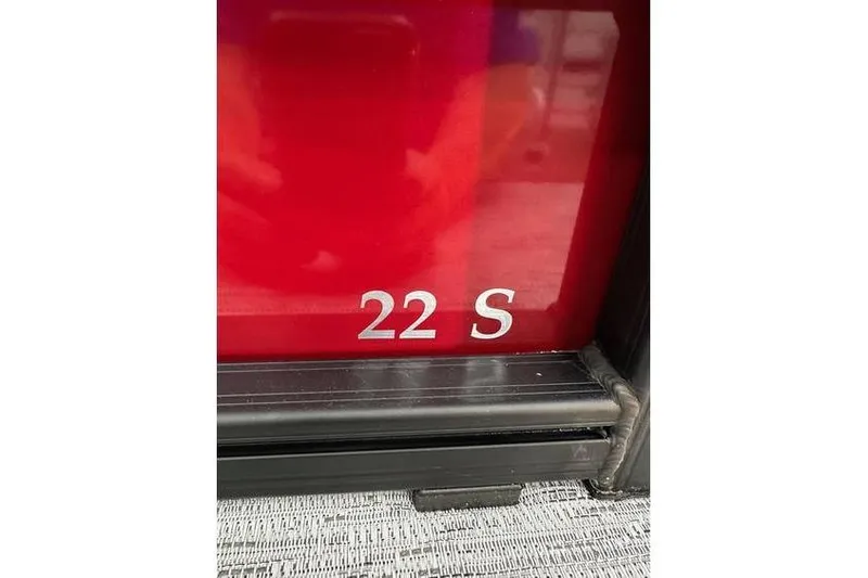 Slide: The Image of Close-up of 2026 Bennington 22 SSR Quad Bench model number on red surface. - 5